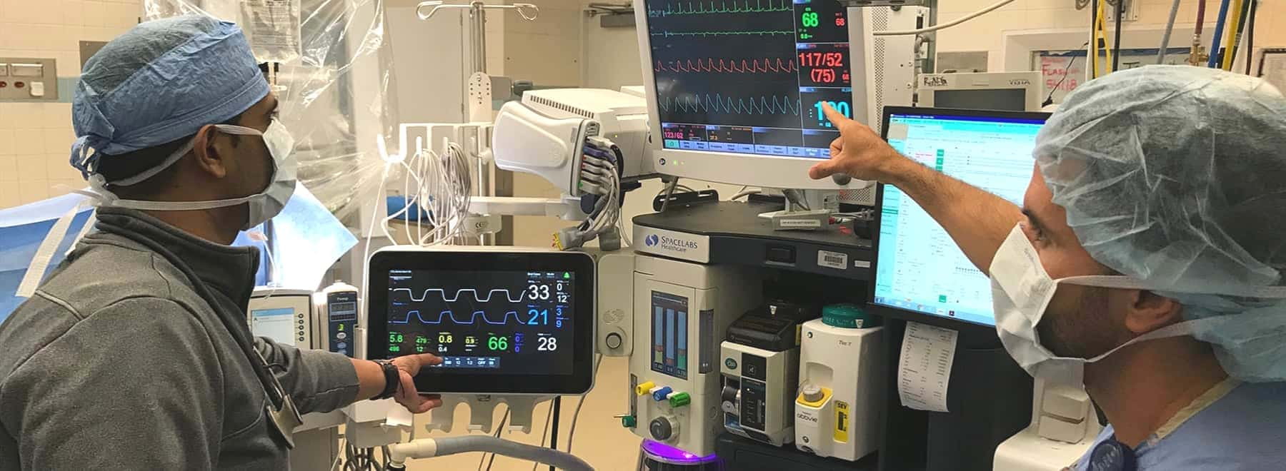 A UMMC faculty member demonstrates an operating room anesthesia technique for a resident.